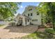 This backyard features a large stone patio and attached sunroom, perfect for relaxing or entertaining guests at 223 Hawthorne Rd, Raleigh, NC 27605