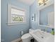 Charming bathroom with blue walls, vintage fixtures, and natural light at 223 Hawthorne Rd, Raleigh, NC 27605