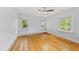 Well-lit bedroom featuring hardwood floors and double windows showcasing green outdoor views at 223 Hawthorne Rd, Raleigh, NC 27605