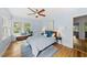 Bright bedroom featuring hardwood floors, a ceiling fan, and ample natural light at 223 Hawthorne Rd, Raleigh, NC 27605