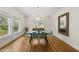 Light-filled dining room with modern furniture, wood floors, and backyard views at 223 Hawthorne Rd, Raleigh, NC 27605