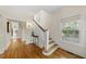 Bright foyer with hardwood floors and staircase with natural light through large window at 223 Hawthorne Rd, Raleigh, NC 27605