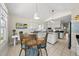 Bright kitchen with dining area, black countertops, white cabinets, and an island at 223 Hawthorne Rd, Raleigh, NC 27605