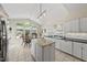 Bright kitchen boasts an island, granite countertops, and a dining area with backyard views at 223 Hawthorne Rd, Raleigh, NC 27605