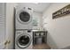 Efficient laundry room with stacked washer/dryer and charming decor accents at 223 Hawthorne Rd, Raleigh, NC 27605