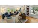 Sunlit living room featuring hardwood floors, built-in bookshelves, fireplace, and comfortable seating at 223 Hawthorne Rd, Raleigh, NC 27605