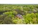 Scenic aerial view of a brick home surrounded by lush greenery and mature trees at 2238 Lakeview Ter, Burlington, NC 27215