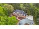 A stately brick home with a paved driveway, manicured lawn, mature trees, and professional landscaping at 2238 Lakeview Ter, Burlington, NC 27215