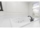 All-white bathroom with large soaking tub, tile border and black fixtures at 2238 Lakeview Ter, Burlington, NC 27215