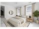 Furnished bedroom with neutral carpeting, two windows, ceiling fan and a large bed at 2238 Lakeview Ter, Burlington, NC 27215
