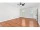 Bright bedroom with hardwood floors, ceiling fan, and natural light from two windows at 2238 Lakeview Ter, Burlington, NC 27215