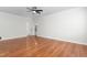 A clean bedroom with hardwood floors, ceiling fan, and a view to the bathroom and closet at 2238 Lakeview Ter, Burlington, NC 27215