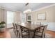Dining room featuring a wooden dining table, an area rug, modern chandelier, and natural light from multiple windows at 2238 Lakeview Ter, Burlington, NC 27215