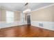 Bright dining room featuring hardwood floors, wainscoting, large windows, and a modern chandelier at 2238 Lakeview Ter, Burlington, NC 27215