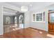 Bright entryway featuring hardwood floors, large window, and view into living area and backyard pool at 2238 Lakeview Ter, Burlington, NC 27215