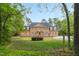 Attractive two-story brick home featuring symmetrical design, dormer windows, shutters, and mature landscaping at 2238 Lakeview Ter, Burlington, NC 27215