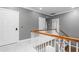 Upstairs hallway with neutral carpet and paint and wood and white banister at 2238 Lakeview Ter, Burlington, NC 27215