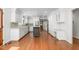 Spacious kitchen featuring white cabinetry, stainless steel appliances, and large center island with dark wood accents at 2238 Lakeview Ter, Burlington, NC 27215