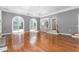 Open living room with hardwood floors, gray walls, arched windows, and access to the backyard at 2238 Lakeview Ter, Burlington, NC 27215