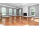 Light-filled living room with hardwood floors, arched windows, fireplace, and chandelier at 2238 Lakeview Ter, Burlington, NC 27215