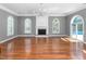 Spacious living room with hardwood floors, gray walls, arched windows, and chandelier at 2238 Lakeview Ter, Burlington, NC 27215