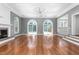Bright living room features hardwood floors, fireplace, and arched windows overlooking the pool at 2238 Lakeview Ter, Burlington, NC 27215