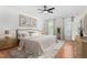 Bright staged bedroom with hardwood floors, ceiling fan, and natural light from two windows at 2238 Lakeview Ter, Burlington, NC 27215