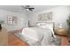 A clean bedroom with hardwood floors, ceiling fan, and staging furniture at 2238 Lakeview Ter, Burlington, NC 27215