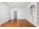Sunlit office features beautiful hardwood floors, custom built-in shelves, and white trim at 2238 Lakeview Ter, Burlington, NC 27215