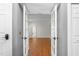 Open French doors reveal a bright office space with clean gray walls and hardwood floors at 2238 Lakeview Ter, Burlington, NC 27215
