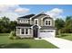 Charming two-story home featuring gray siding, stone accents, and a two-car garage at 224 Sprenger St, Garner, NC 27529