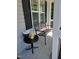 Comfortable seating and table for enjoying the outdoors on the covered front porch at 236 Bragg Ln, Hurdle Mills, NC 27541