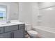 Bright bathroom featuring white toilet and shower with gray cabinets, and updated fixtures at 244 Paramount Dr # 24, Smithfield, NC 27577
