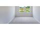 Cozy bedroom featuring neutral carpet, white walls, and view of the community playground through the windows at 244 Paramount Dr # 24, Smithfield, NC 27577