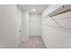 Walk-in closet with carpet flooring, white walls, and ample shelving at 244 Paramount Dr # 24, Smithfield, NC 27577
