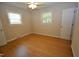 Cozy bedroom with hardwood floors, ceiling fan, two windows letting in natural light, and neutral-colored walls at 2805 Nc 55, Durham, NC 27713