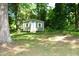 Backyard shed painted green with white trim surrounded by lush greenery at 2805 Nc 55, Durham, NC 27713