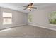 Spacious carpeted bedroom with a ceiling fan and natural light from three windows at 3002 Remington Oaks Cir, Cary, NC 27519