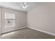 Bright carpeted bedroom featuring a large window and neutral color scheme at 3002 Remington Oaks Cir, Cary, NC 27519