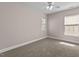 Cozy carpeted bedroom featuring two large windows providing natural light at 3002 Remington Oaks Cir, Cary, NC 27519