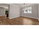 Open dining area featuring a window and modern light fixture at 3002 Remington Oaks Cir, Cary, NC 27519