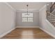 Dining area with hardwood floors, a window, and staircase access at 3002 Remington Oaks Cir, Cary, NC 27519
