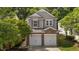 Charming home featuring a brick and siding facade with a two-car garage and mature trees at 3002 Remington Oaks Cir, Cary, NC 27519