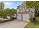 Attached two-car garage providing ample parking and storage with a brick and vinyl exterior at 3002 Remington Oaks Cir, Cary, NC 27519