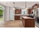 Modern kitchen with stainless steel appliances, wood cabinets and island at 3002 Remington Oaks Cir, Cary, NC 27519