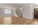 Living area featuring hardwood floors, lots of natural light, and staircase at 3002 Remington Oaks Cir, Cary, NC 27519