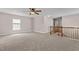 Upstairs loft featuring carpet, ceiling fan, and natural light at 3002 Remington Oaks Cir, Cary, NC 27519