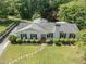 An aerial view showing the front exterior of the home, the lawn, and the driveway at 306 Holland Rd, Fuquay Varina, NC 27526