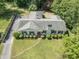 An aerial perspective showing a charming home with a manicured lawn and mature landscaping at 306 Holland Rd, Fuquay Varina, NC 27526