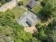 An aerial view showing a large home with mature trees, lush landscaping, and a driveway at 306 Holland Rd, Fuquay Varina, NC 27526